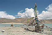 Ladakh - pile of stones on  mountain pass with the characteristc prayer flags 